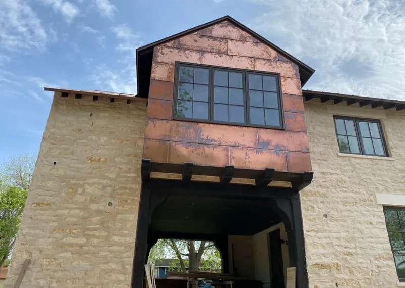 Copper metal panel facade on a stone building for Skylight Installation in South Valley