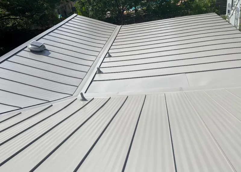 Solar attic fan installed on a metal roof for Roof Ventilation in South Valley